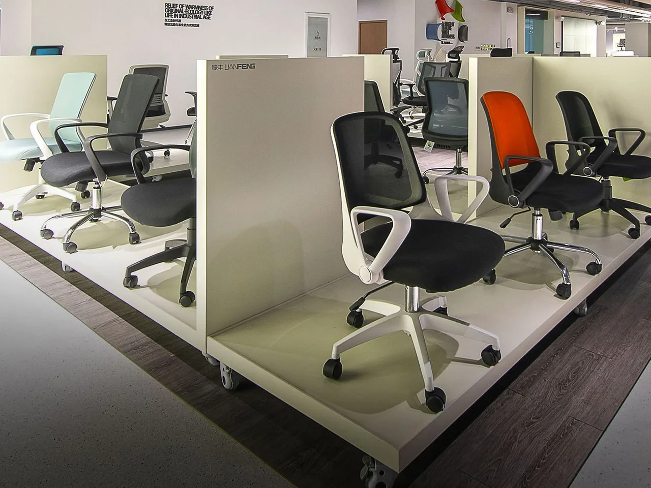 Task chairs on branded display platforms in the LIANFENG showroom of Anji Fuhe Furniture